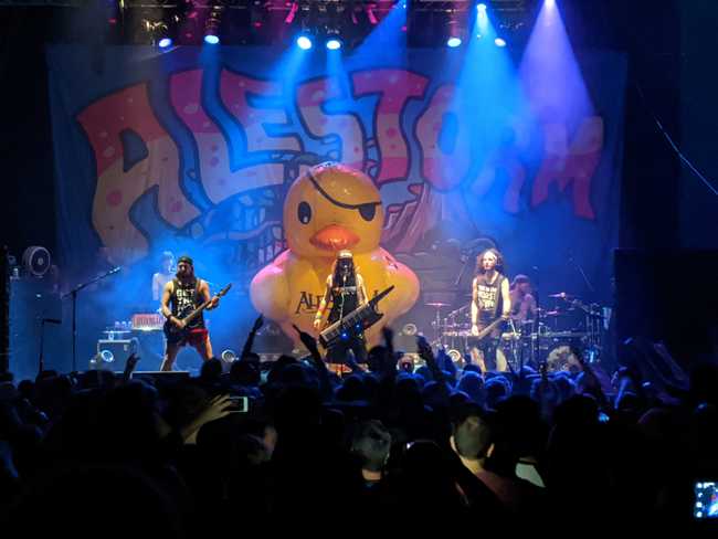 Heavy metal band performing with flood lights and a giant
inflated rubber duck.