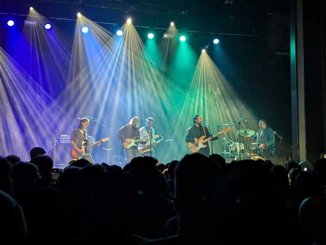 It's the same crew as before (in a slightly different order), but now there's a guy playing saxophone in the
back.