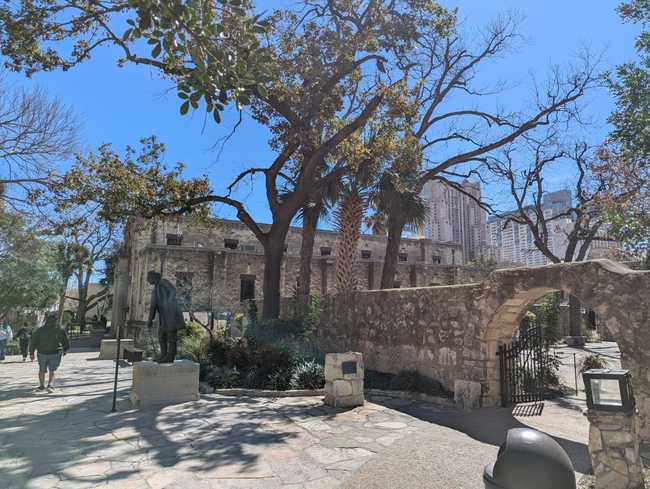 There's a stone courtyard with a statue on the left; a stone wall with a gate on the right; and a building that looks
like a church in the back (but it's actually a gift shop).
