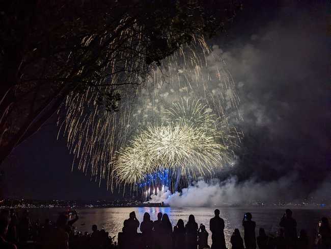 A fireworks display over the water.