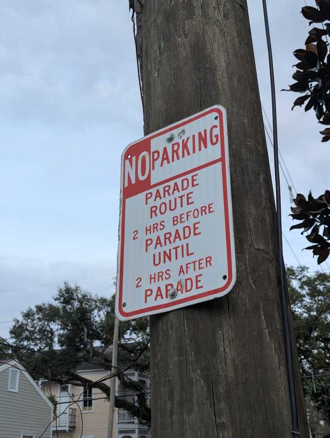 A no parking sign, reading "No parking. Parade route. 2 hours before parade until 2 hours after parade."