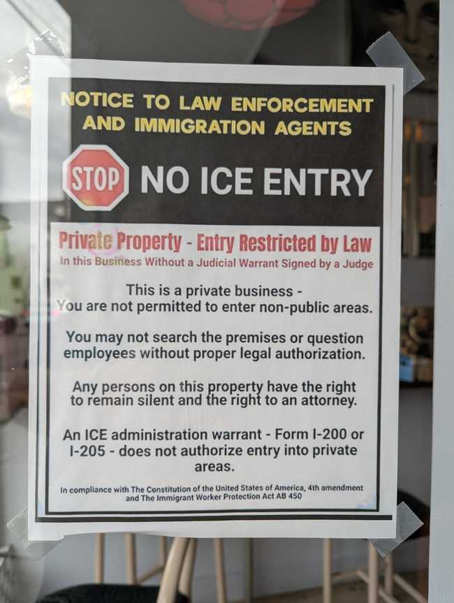 A "No ICE entry" sign taped to a door.
