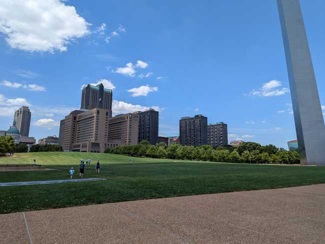 Looking from the ground beneath the arch back to the city. The people on the grass are tiny compared to the single leg
of the arch in the picture.