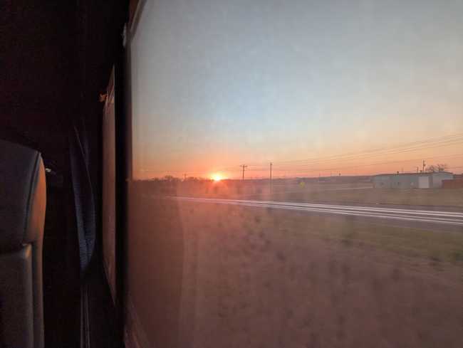 The sunrise as seen through a dirty window.