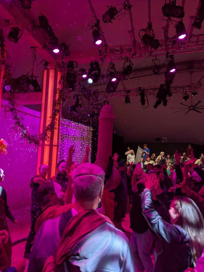 The same stage, but filled with audience members dancing.