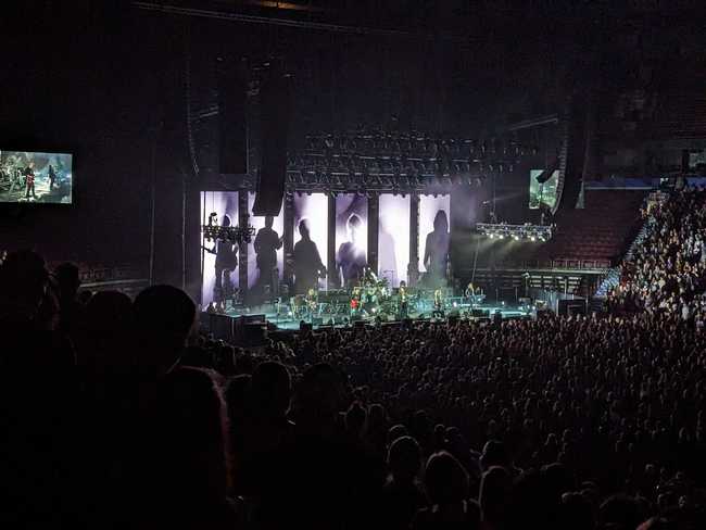 A large crowd inside an arena for a concert.
