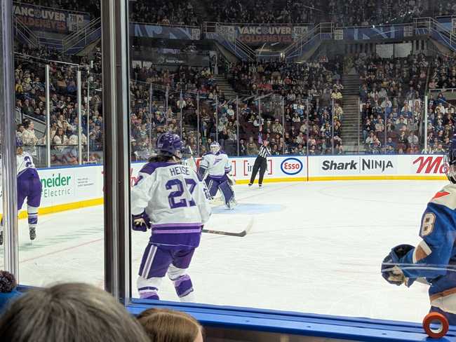 The Frost defence women fetch the puck from behind the goalie.
