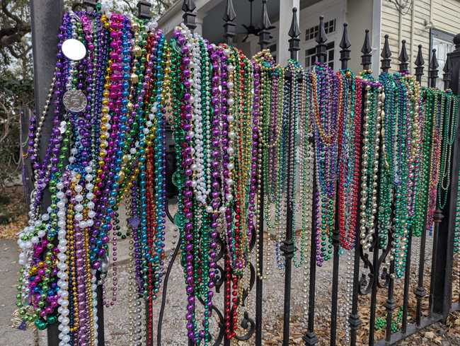 An iron fence covered in beads.