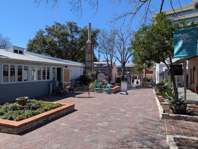 A view small buildings on a pedestrian street. It looks pleasant.